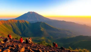 Hikers overlooking Mount Rinjani at sunrise with lush slopes and vibrant sky
